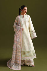 Woman wearing a traditional outfit with intricate patterns on a green background