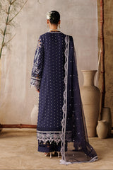 Person wearing a traditional outfit with a lace border in a decorative setting.